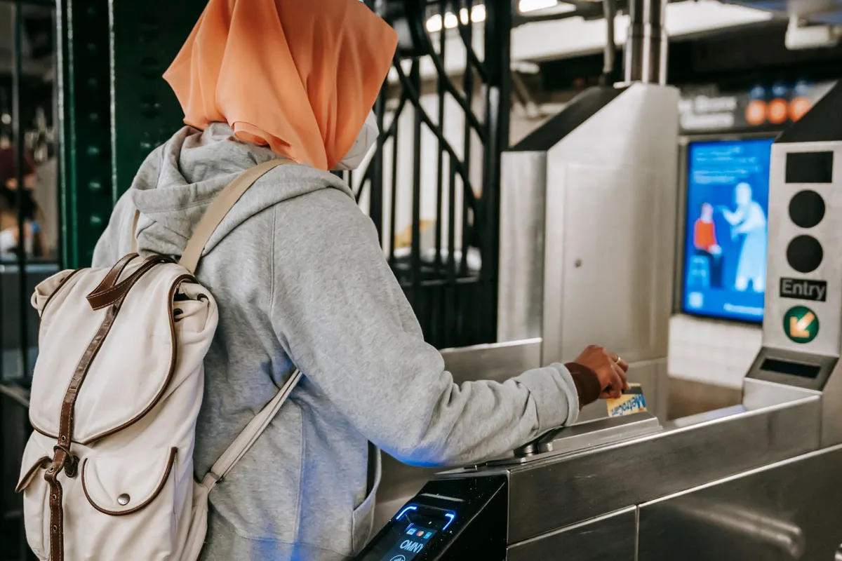 Traveler using a travel card at a metro gate