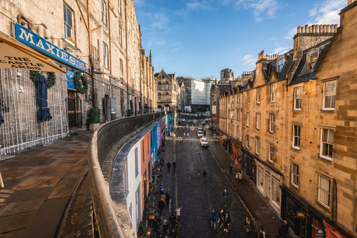 Colorful shops on sloping Victoria Street in Edinburgh