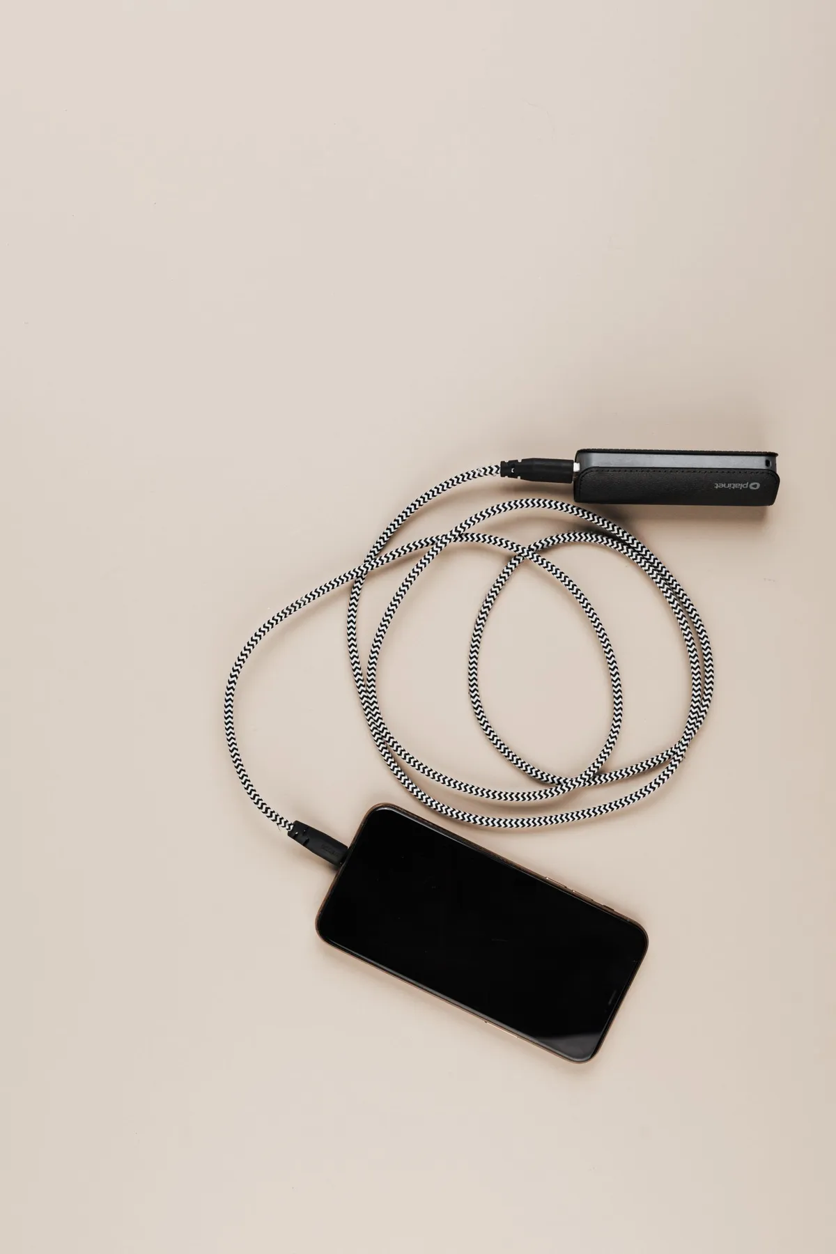 A smartphone connected to a portable power bank