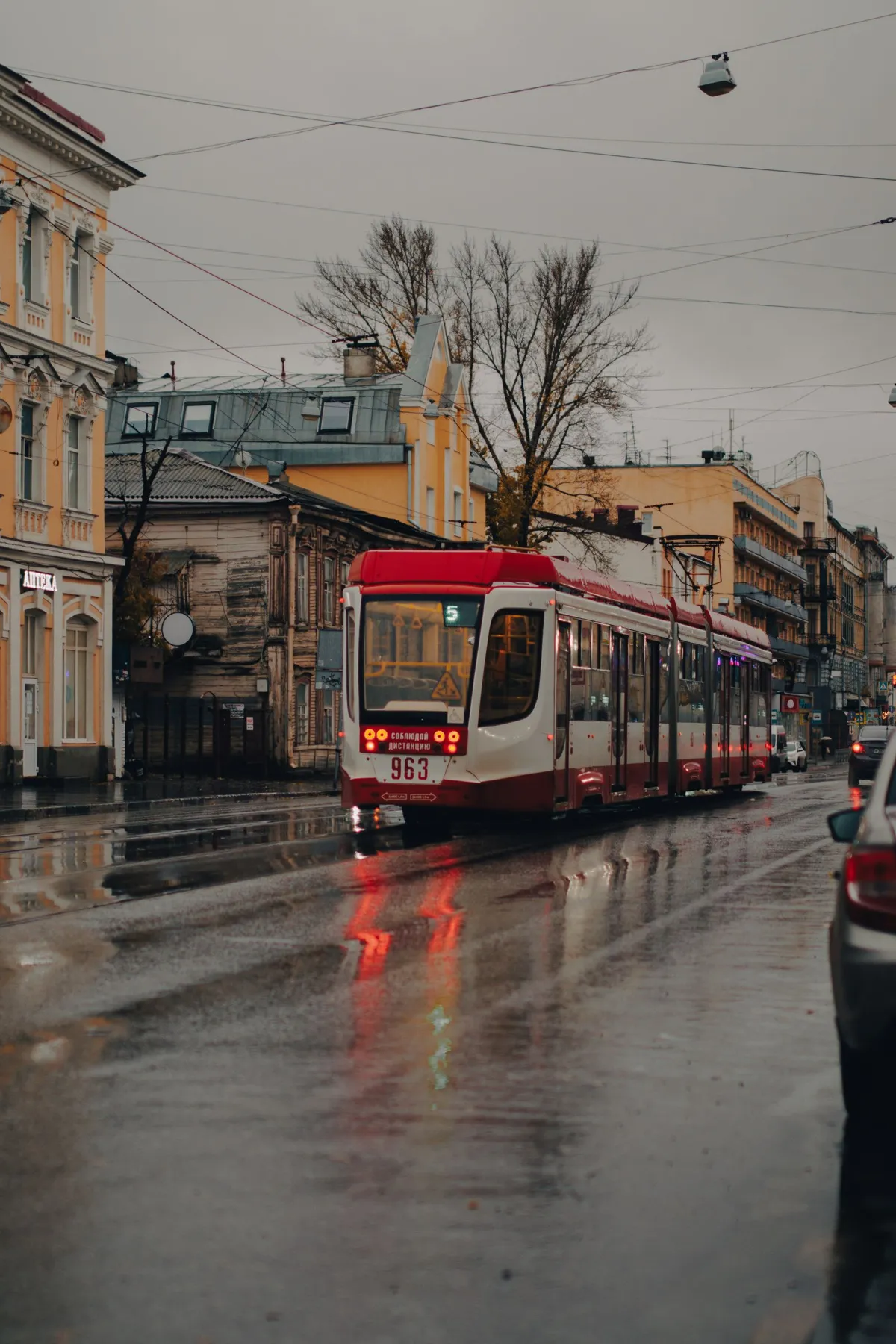 A tram on a rainy city street
