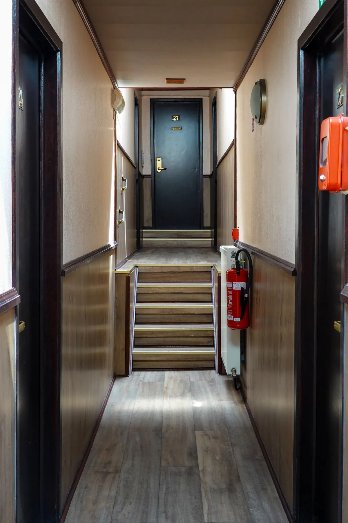 Steps and handrails inside a hotel corridor