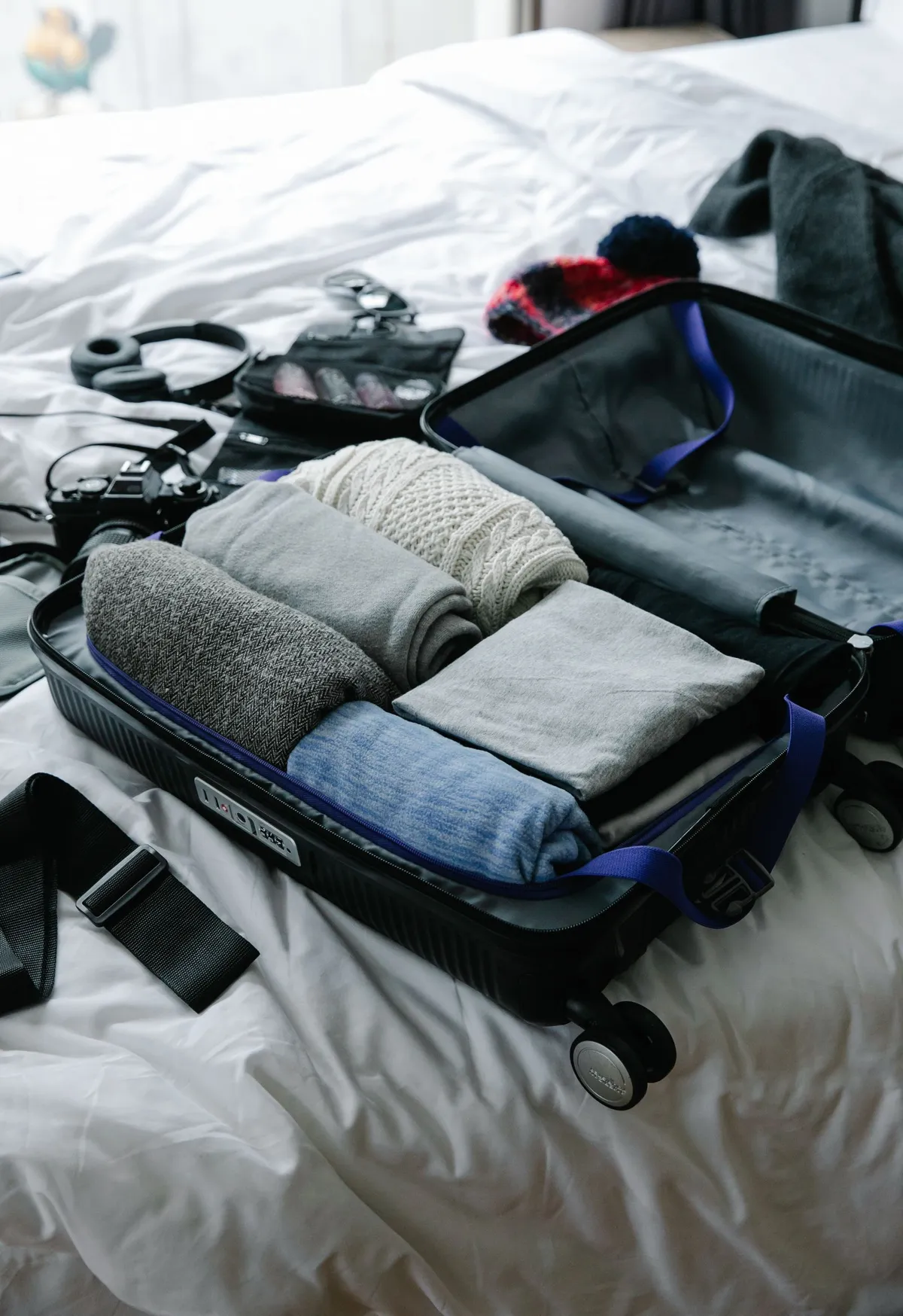 Folded clothes arranged inside an open suitcase